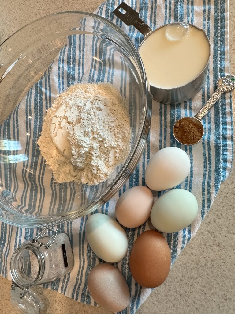 dutch baby pancake ingredients setting on towel on kitchen counter